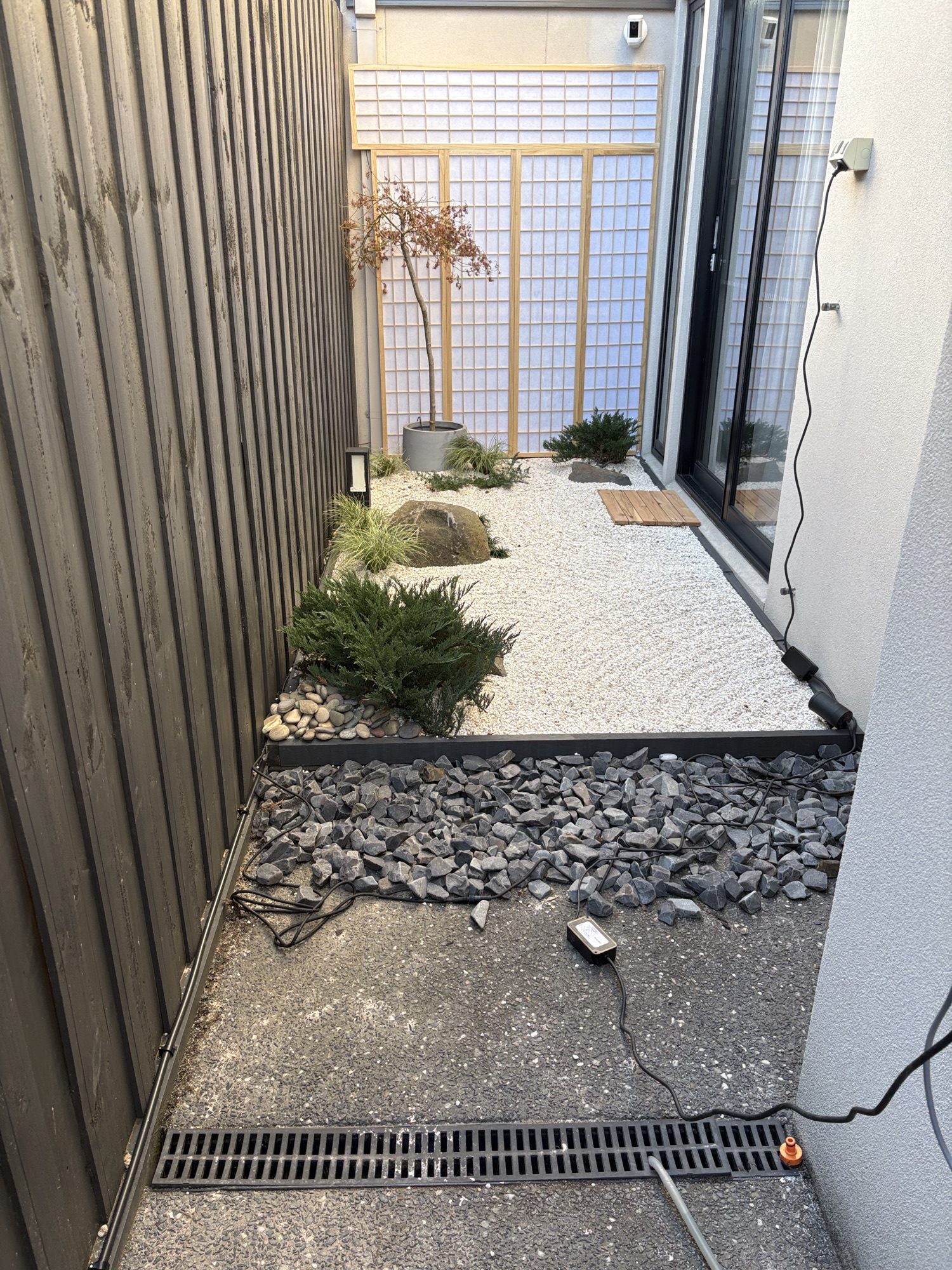 The garden early on, gravel raked but the border still raw crushed rock